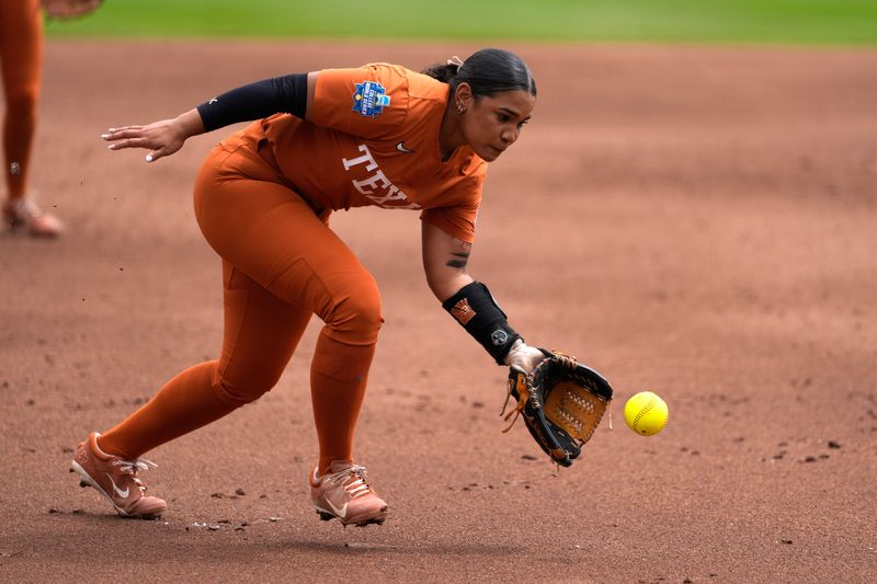 Texas utility Mia Scott (10) fields the ball in the first inning of a Women's College World Series softball game between the Texas Longhorns and the Florida Gators at Devon Park in Oklahoma City, Thursday, May 29, 2025.