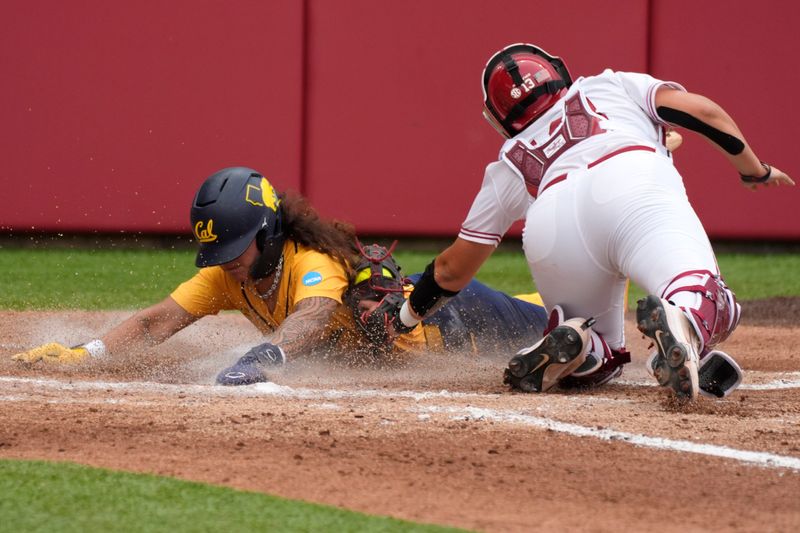 California catcher Lagi Quiroga (4) slides home past Oklahoma catcher Isabela Emerling (13) to score a run in the second inning of a softball game in the Norman Regional of the NCAA Tournament between the University of Oklahoma Sooners (OU) and the California Golden Bears at Love's Field in Norman, Okla., Sunday, May 18, 2025. Oklahoma won 12-1.