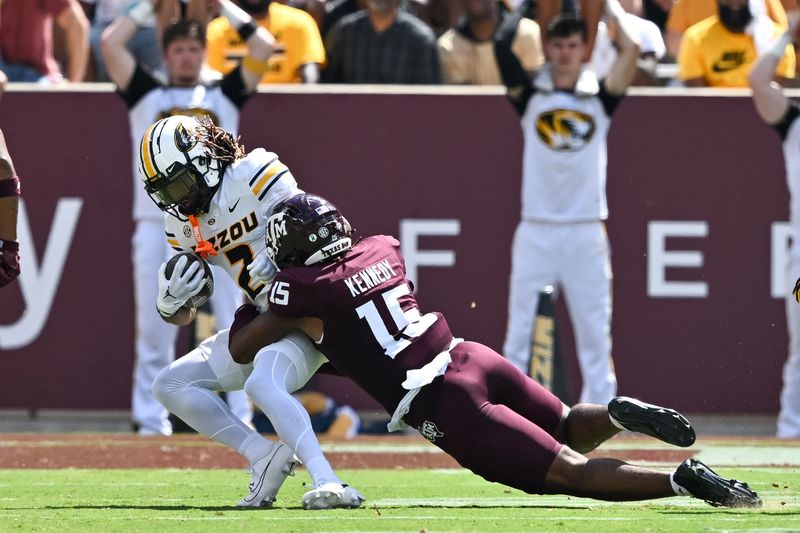 Oct 5, 2024; College Station, Texas, USA; Texas A&M Aggies defensive lineman Rylan Kennedy (15) tackles Missouri Tigers wide receiver Marquis Johnson (2) in the third quarter at Kyle Field. Mandatory Credit: Maria Lysaker-Imagn Images.