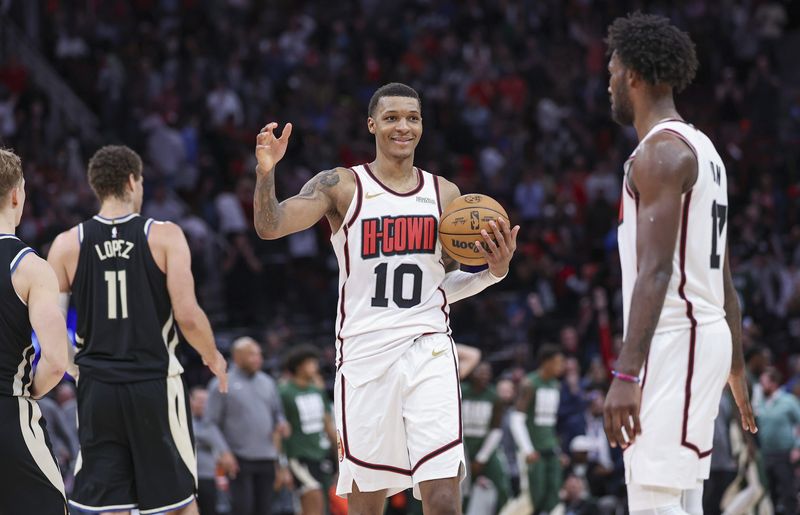 Feb 25, 2025; Houston, Texas, USA; Houston Rockets forward Jabari Smith Jr. (10) smiles and celebrates with forward Tari Eason (17) after the game against the Milwaukee Bucks at Toyota Center. Mandatory Credit: Troy Taormina-Imagn Images