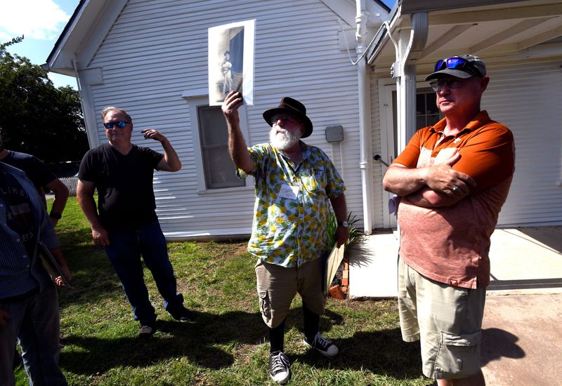 Bill Cavalier holds up a photograph of author Robert E. Howard dressed in Mexican attire during Robert E. Howard Days in Cross Plains June 14. Howard would often wear costumes similar to his characters as a way to physically work out their stories — often in his backyard with friends.