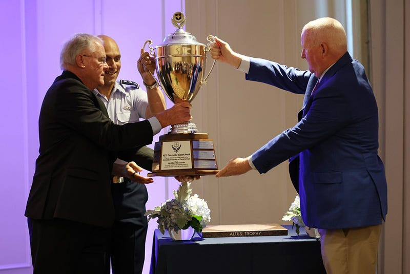 Dr. Joe Leverett of the Altus Chamber of Commerce, right, presents the Altus Award to Lt. Gen. Brian Robinson, commander of the Air Education and Training Command, and Sheppard Military Affairs Committee President Glenn Barham.