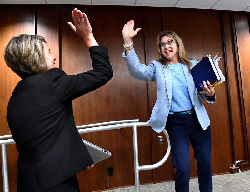 Interim City Manager Mindy Patterson (right) high-fives incoming City Manager Emily Crawford as she turns her duties over to Crawford during Thursday’s Abilene City Council meeting. Patterson took over in the interim from retiring Abilene City Manager Robert Hanna March 28 while a search was conducted for his replacement. Patterson is planning her own retirement for August.