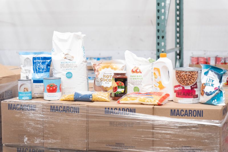 Non-fat milk and other shelf-stable pantry food staples from the Church of Jesus Christ of Latter-Day Saints are delivered and placed into storage at High Plains Food Bank.