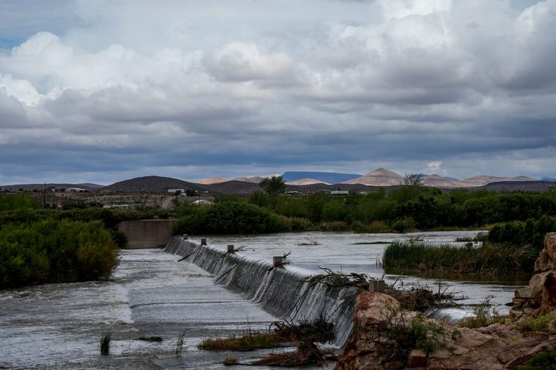 Rain clouds are seen to the north of Leasburg Diversion Dam in Las Cruces, New Mexico during a period of rain in late June 2025.