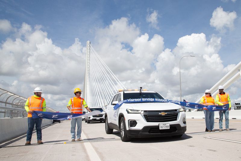 A Texas Department of Transportation vehicle breaks a ribbon as it crosses the new Harbor Bridge in Corpus Christi on June 28.