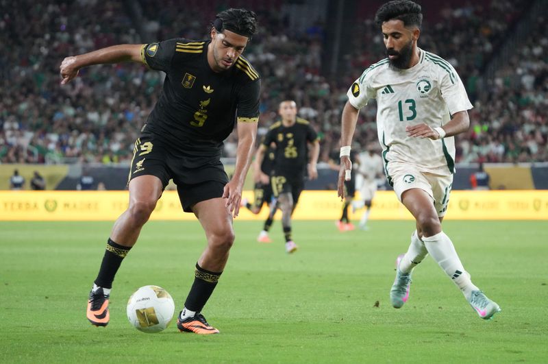 Jun 28, 2025; Glendale, Arizona, USA; Mexico forward Raul Jimenez (9) dribbles against Saudi Arabia defender Nawaf Bu Washl (13) in the first half during a quarterfinal match of the 2025 Gold Cup at State Farm Stadium. Mandatory Credit: Joe Camporeale-Imagn Images