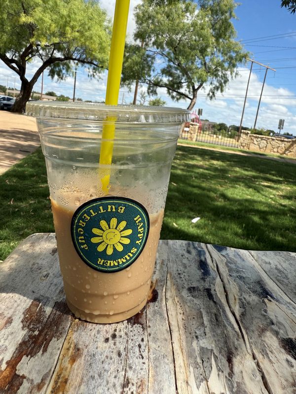 An iced coffee from Buttercup All Day Cafe, 1921 Sherwood Way, builds condensation at the park.