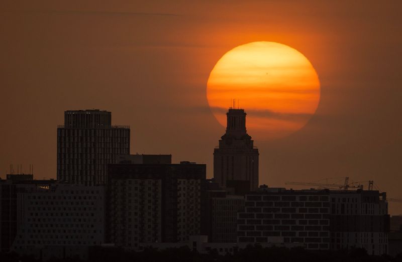 The sun rises over the University of Texas through Saharan dust in Austin, Tuesday, July 1, 2025. The dust from the Sahara in North Africa has traveled 6,000 miles to Texas and is giving Austin a hazy sky and vibrant sunrises and sunsets. The layer of dust, floating about 10,000 feet above the ground, can aggravate allergies and asthma, and cause itchy eyes, sneezing, coughing and nasal congestion. The plume of Saharan dust will hang over Central Texas until midweek.
