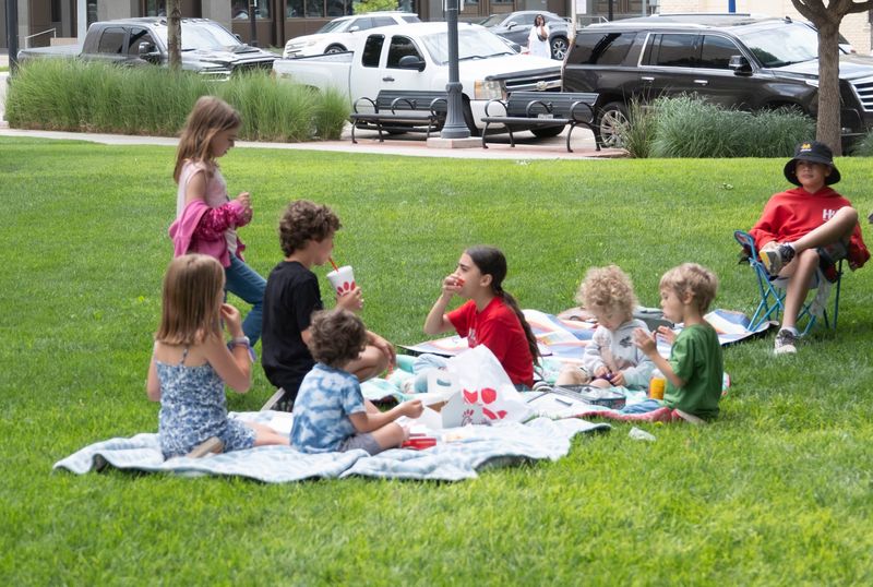 Children enjoy lunch and games on the courthouse lawn during High Noon on the Square on July 2 in downtown Amarillo. The weekly summer series draws families from across the city for food, live music and community tradition.