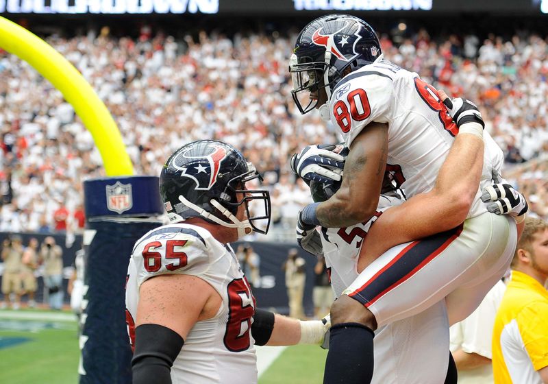 Sep 11, 2011; Houston, TX, USA; Houston Texans wide receiver Andre Johnson (80), center Chris Myers (55), and offensive guard Mike Brisiel (65) celebrate a touchdown against the Indianapolis Colts at Reliant Stadium. The Texans defeated the Colts 34-7. Mandatory Credit: Jerome Miron-USA TODAY Sports