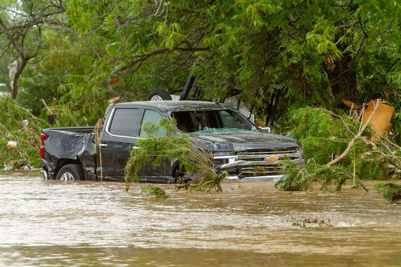 Record-breaking flooding swept cars and debris down to the corner of North Marie Street and Koberlin Street after 14 inches of rainfall in San Angelo on Friday, July 4, 2025.
