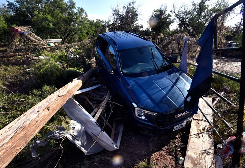 An SUV is wedged onto debris along Koberlin St. after the previous day’s flood in San Angelo Saturday July 5, 2025.