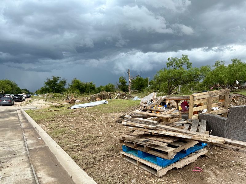 Debris is piled up on the side of the road on July 6 off Bell Street in San Angelo after the Fourth of July flood
