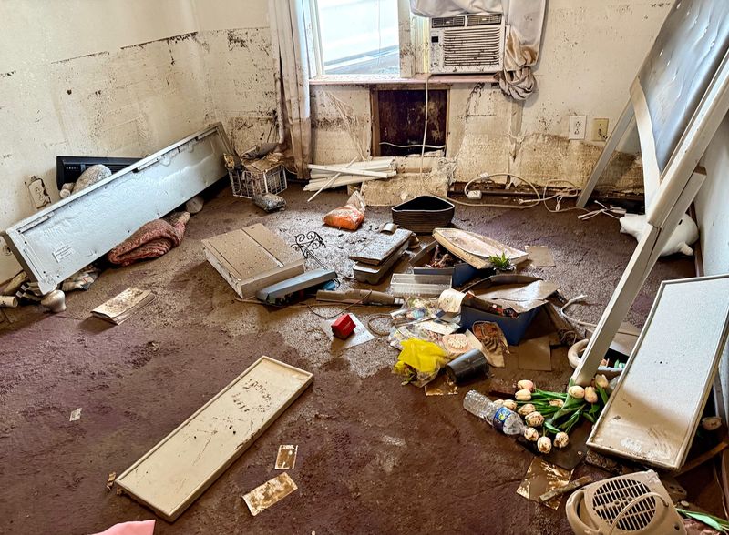 Items sit in muddy water in a child's room in a home off Bell Street on July 6 in San Angelo following the Fourth of July flood.