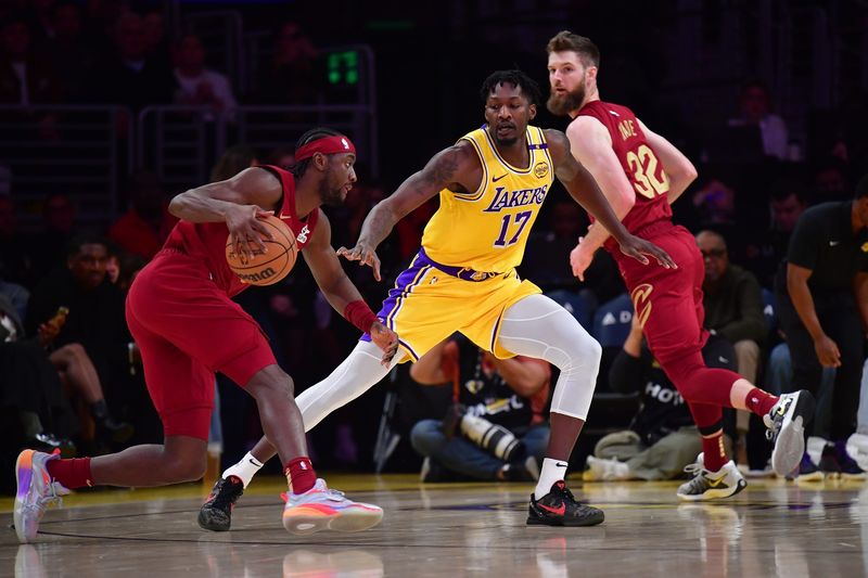 Dec 31, 2024; Los Angeles, California, USA; Los Angeles Lakers forward Dorian Finney-Smith (17) defends against Cleveland Cavaliers guard Caris LeVert (3) during the first half at Crypto.com Arena. Mandatory Credit: Gary A. Vasquez-Imagn Images