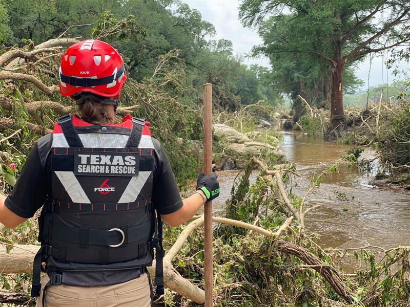 TEXSAR search-and-rescue volunteers scour the banks of the Guadalupe River, looking for victims of the recent floods. The group has deployed 50 volunteers and six swift-water rescue boats to help search for victims.
