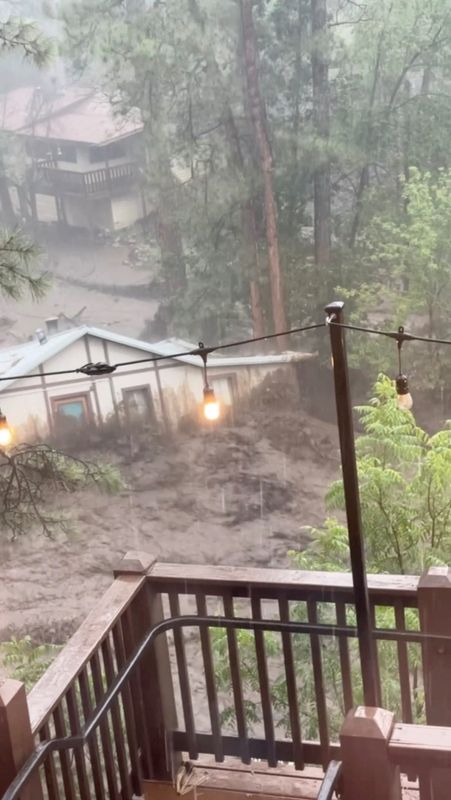 A flood sweeps away a house in Ruidoso, New Mexico, U.S., July 8, 2025, in this screen grab obtained from social media video.