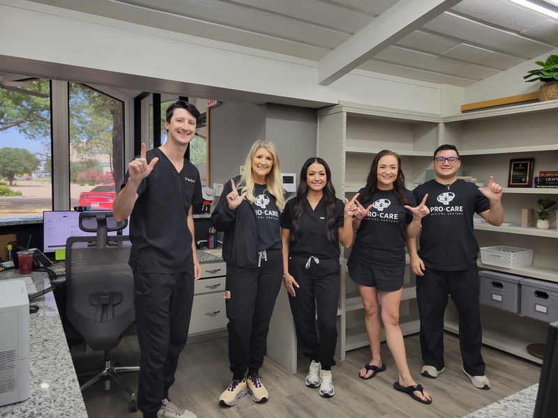 Dr. Greg Polson, Allison Cartwright, Michelle Arriola, Morgan Polson and Bryce Milner do the Texas Tech 'Guns Up' sign, on Monday, July 7, 2025 at ProCare Injury Specialists, 2318 50th St., in Lubbock, Texas.