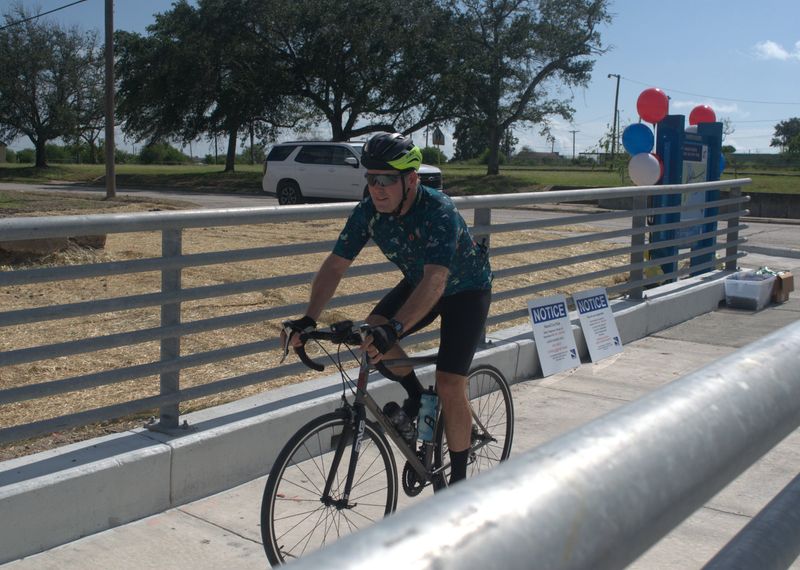Jonathan Martin, a Corpus Christi cyclist and retired physician, rides on the shared-use path on the new Harbor Bridge on July 11. Martin was the first person to cross the path after it opened at 10 a.m. that day.