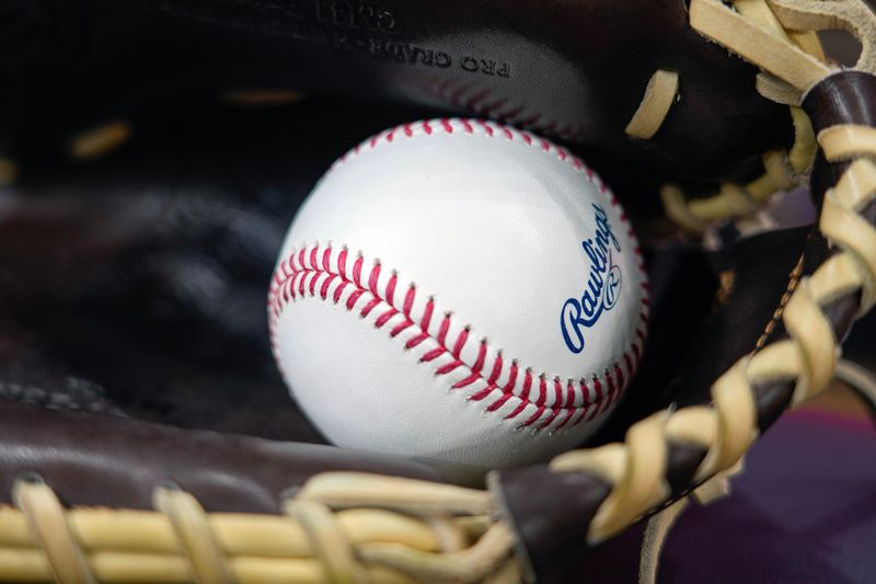 Apr 18, 2025; Milwaukee, Wisconsin, USA; General view of a baseball in a glove during batting practice prior to the game between the Athletics and Milwaukee Brewers at American Family Field. Mandatory Credit: Jeff Hanisch-Imagn Images