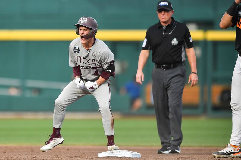 Texas A&M's Travis Chestnut (4) celebrates making it to second after bunting the ball, during game three of the NCAA College World Series finals between Tennessee and Texas A&M at Charles Schwab Field in Omaha, Neb., on Monday, June 24, 2024.