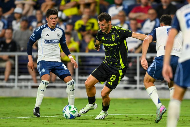 Jul 16, 2025; Nashville, Tennessee, USA; Columbus Crew midfielder Dániel Gazdag (8) dribbles the ball against the Nashville SC during the second period at Geodis Park. Mandatory Credit: Steve Roberts-Imagn Images