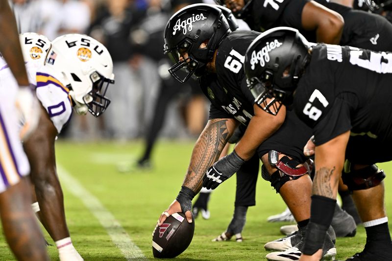 Oct 26, 2024; College Station, Texas, USA; Texas A&M Aggies offensive lineman Kolinu'u Faaiu (61) sets the ball in the fourth quarter against the LSU Tigers at Kyle Field. Mandatory Credit: Maria Lysaker-Imagn Images.