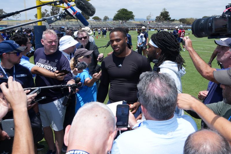 Jul 22, 2025; Oxnard, CA, USA; Dallas Cowboys defensive end Micah Parsons (left) and cornerback Trevon Diggs talks to media during training camp at the River Ridge Fields. Mandatory Credit: Kirby Lee-Imagn Images