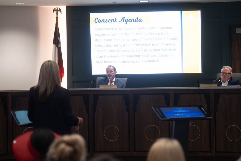 Councilmembers David Prescott and Les Simpson listen during the consent agenda portion of the July 22 Amarillo City Council meeting as a staff member addresses the dais.