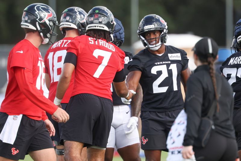 Jul 23, 2025; Houston, TX, USA; Houston Texans running back Nick Chubb (21) shakes hands with quarterback C.J. Stroud (7) during training camp at Houston Methodist Training Center. Mandatory Credit: Troy Taormina-Imagn Images