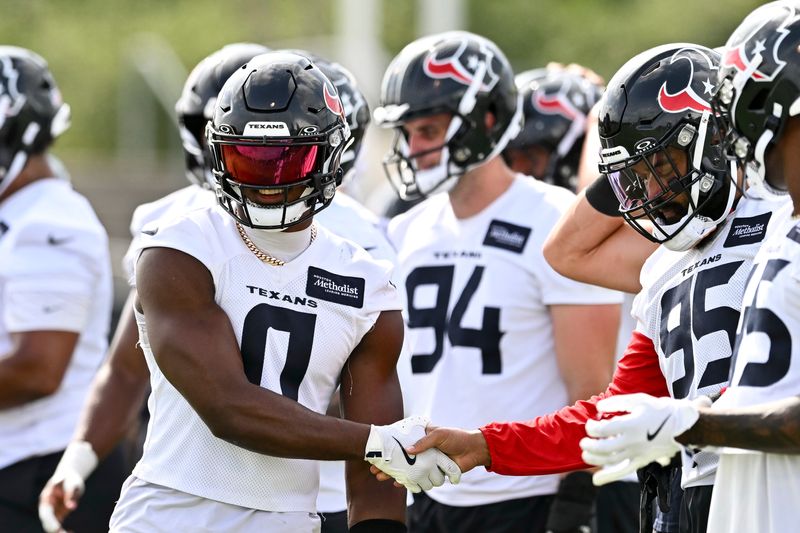 Jun 10, 2025; Houston, TX, USA; Houston Texans linebacker Azeez Al-Shaair (0) greets defensive end Derek Barnett (95) during an NFL football minicamp at NRG Stadium. Mandatory Credit: Maria Lysaker-Imagn Images