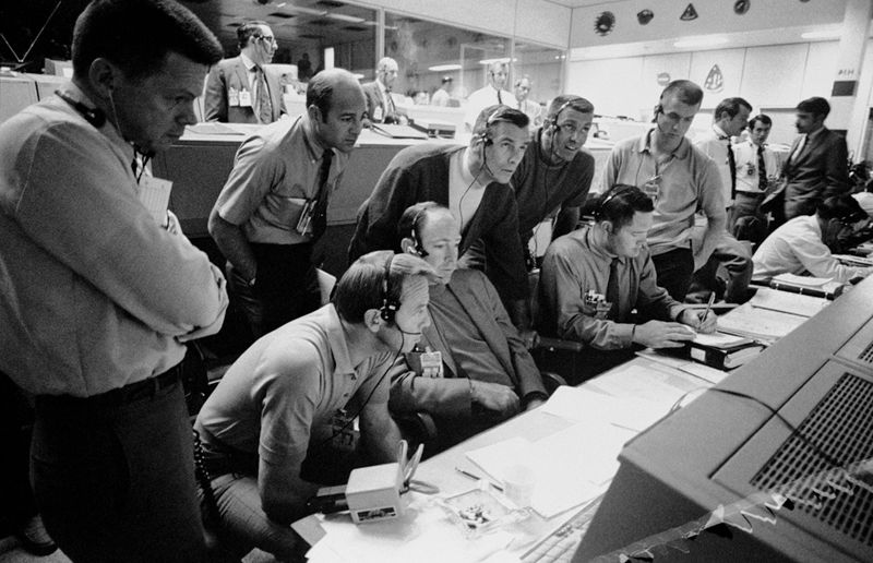 Six astronauts and two flight controllers monitor the console activity in the Mission Operations Control Room of the Mission Control Center in Houston during the problem-plagued Apollo 13 lunar landing mission in 1970.
