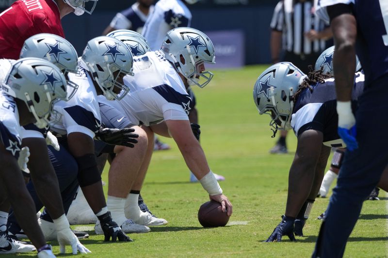 Jul 26, 2025; Oxnard, CA, USA; A general view of helmets at the line of scrimmage as Dallas Cowboys center Cooper Beebe (56) snaps the ball at training camp at the River Ridge Fields. Mandatory Credit: Kirby Lee-Imagn Images