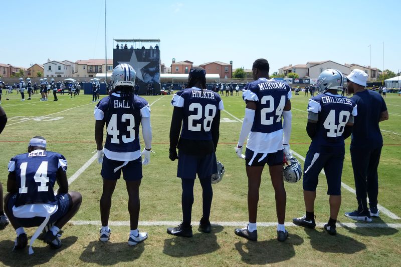 Jul 26, 2025; Oxnard, CA, USA; Dallas Cowboys safety Markquese Bell (14), linebacker Darius Harris (43), safety Malik Hooker (28), safety Israel Mukuamu (24) and cornerback Zion Childress (48) watch from the sidelines at training camp at the River Ridge Fields. Mandatory Credit: Kirby Lee-Imagn Images