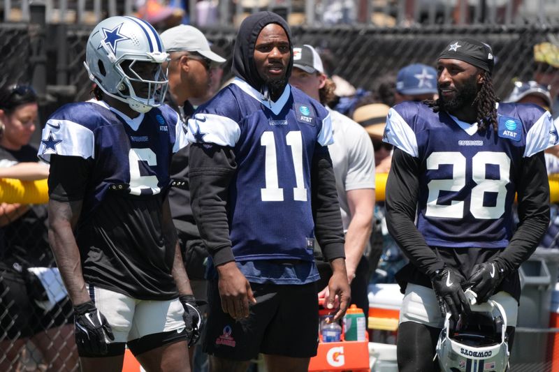 Jul 27, 2025; Oxnard, CA, USA; Dallas Cowboys safety Donovan Wilson (6), defensive end Micah Parsons (11) and safety Malik Hooker (28) watch from the sidelines at training camp at the River Ridge Fields. Mandatory Credit: Kirby Lee-Imagn Images