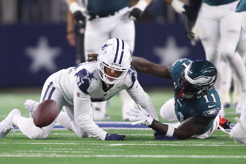 Dec 10, 2023; Arlington, Texas, USA; Philadelphia Eagles wide receiver A.J. Brown (11) fumbles the ball after being tackled by Dallas Cowboys cornerback Stephon Gilmore (21) in the second half at AT&T Stadium. Mandatory Credit: Tim Heitman-USA TODAY Sports
