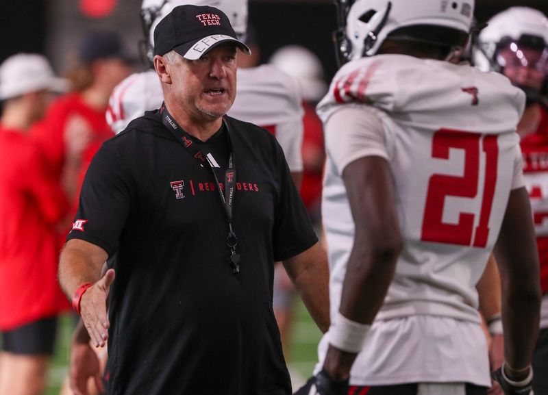 Head coach Joey McGuire talks to players during Texas Tech football practice, Thursday, July 31, 2025, at the Womble Football Center.