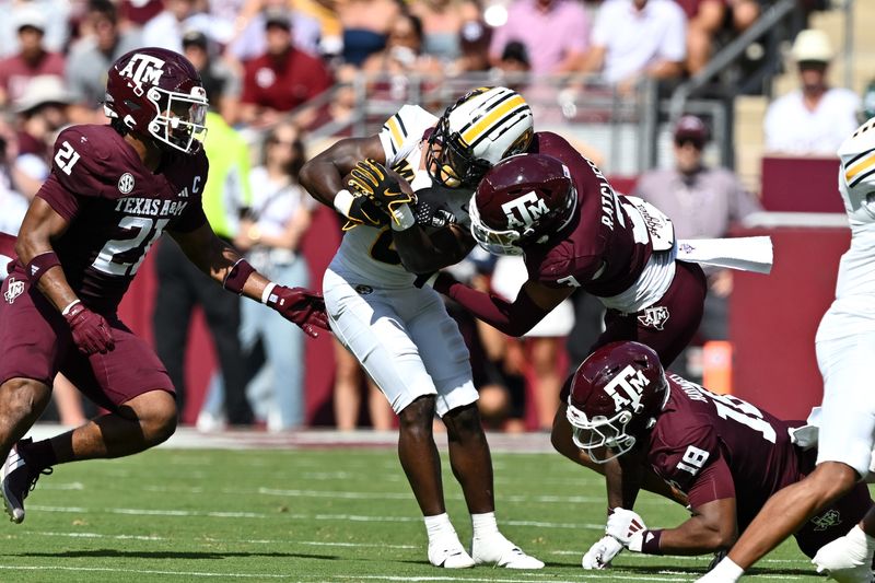 Oct 5, 2024; College Station, Texas, USA; Texas A&M Aggies defensive back Marcus Ratcliffe (3) tackles Missouri Tigers running back Nate Noel (8) in the first quarter at Kyle Field. Mandatory Credit: Maria Lysaker-Imagn Images.