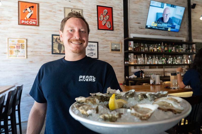 Martin Armendariz Jr. serves up a plate of oysters on the half shell in his new Pearl Divers Oyster Bar in Downtown El Paso on Aug. 5, 2025. Martin Armendariz Jr. is the owner of now two neighboring restaurants in Downtown El Paso.