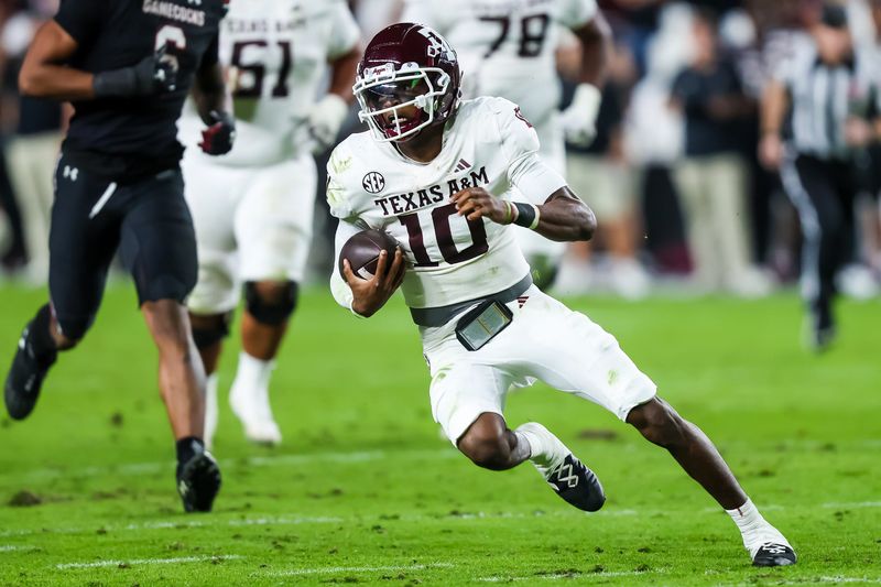 Nov 2, 2024; Columbia, South Carolina, USA; Texas A&M Aggies quarterback Marcel Reed (10) scrambles against the South Carolina Gamecocks in the second quarter at Williams-Brice Stadium. Mandatory Credit: Jeff Blake-Imagn Images