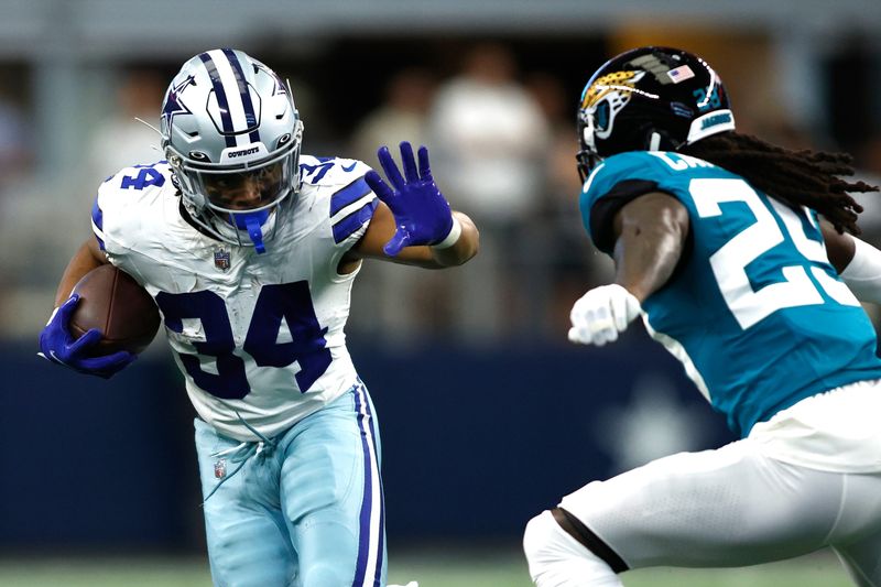 Aug 12, 2023; Arlington, Texas, USA; Dallas Cowboys running back Malik Davis (34) runs the ball against Jacksonville Jaguars running back D'Ernest Johnson (25) in the first quarter at AT&T Stadium. Mandatory Credit: Tim Heitman-USA TODAY Sports