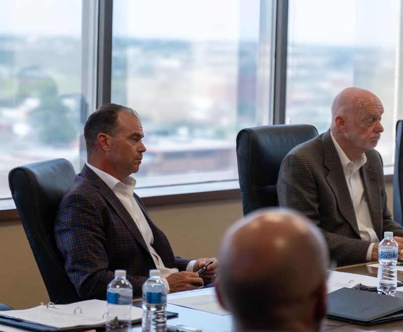 Elliot McKinney, left, listens during the Aug. 12 meeting of the Amarillo Economic Development Council, where he was unanimously elected chair.