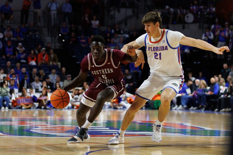 Nov 22, 2024; Gainesville, Florida, USA; Southern Illinois Salukis guard Ali Dibba (6) drives to the basket against Florida Gators forward Alex Condon (21) during the first half at Exactech Arena at the Stephen C. O'Connell Center. Mandatory Credit: Matt Pendleton-Imagn Images