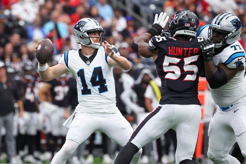 Aug 16, 2025; Houston, Texas, USA; Carolina Panthers quarterback Andy Dalton (14) attempts a pass as Houston Texans defensive end Danielle Hunter (55) applies defensive pressure during the first quarter at NRG Stadium. Mandatory Credit: Troy Taormina-Imagn Images