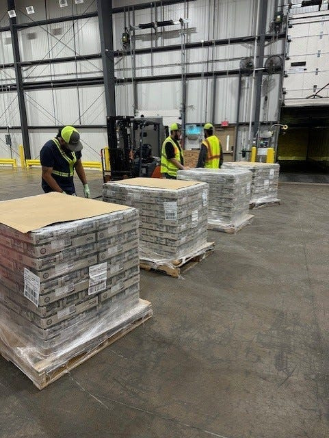 Purina workers in Hereford get pet food ready to ship to the flooded area in Texas Hill Country during July.