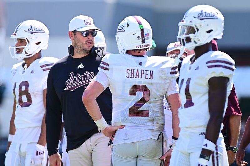 Sep 21, 2024; Starkville, Mississippi, USA; Mississippi State Bulldogs head coach Jeff Lebby speaks with quarterback Blake Shapen (2) during the fourth quarter against the Florida Gators at Davis Wade Stadium at Scott Field. Mandatory Credit: Matt Bush-Imagn Images
