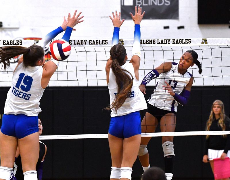 Wylie’s D’Nae Dolton spikes the ball past Frenship’s Brooklyn Cox (left) and Lauryn Hiner during Saturday’s Bev Ball Classic volleyball tournament at Abilene High School Aug. 16, 2025.