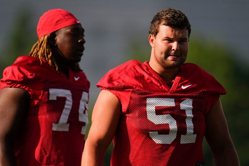 Ohio State Buckeyes offensive lineman Luke Montgomery (51) and offensive lineman Carter Lowe (74) work out during football training camp at the Woody Hayes Athletic Center on Aug. 1, 2025.