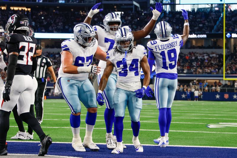 Aug 22, 2025; Arlington, Texas, USA; Teammates celebrate with Dallas Cowboys running back Jaydon Blue (34) after he scores a touchdown against the Atlanta Falcons during the first quarter at AT&T Stadium. Mandatory Credit: Andrew Dieb-Imagn Images